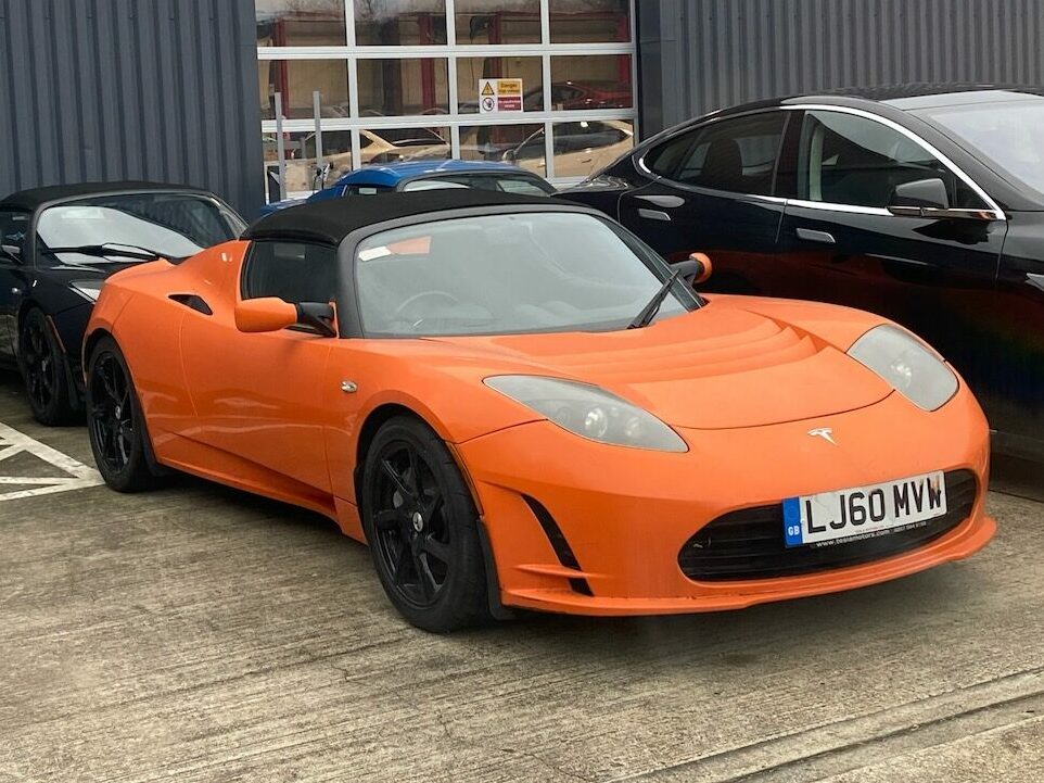 An orange Tesla Roadster 